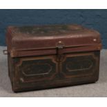 A vintage dome top twin handled tin trunk.
