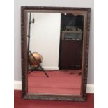 A carved wooden framed mirror. (86 x 60cm)