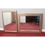 Two framed bevelled edged mirrors. H: 74cm W: 90cm, H: 59cm, W:89cm.