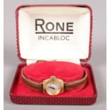 A ladies manual Rone wristwatch with leather strap in original case. Not running.