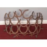 A metal horseshoe wall hanging. H: 42cm, W: 66cm.