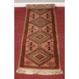 A light brown ground carpet runner with Aztec design. L: 182cm, W:60cm. Condition good. No holes.