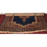A large blue ground wool rug with central medallion design. H: 286cm, W:200cm. Condition good. No