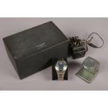 A boxed electric Navigator stainless steel wristwatch. With charging port.