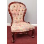 A wooden framed spoon back upholstered chair. Comprising of deep buttoned back and carved