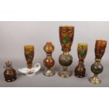 Six coloured glass oil lamps. Including chamber oil lamp with ceramic base example, etc.