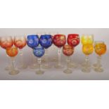 A group of coloured/clear Bohemian crystal hock/wine glasses. various colours blue, red, orange,