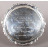 A silver presentation dish raised on three stepped feet. Assayed Sheffield 1938 by Frank Cobb & Co