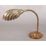 An Art Deco brass adjustable shell lamp.