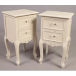 A pair of painted bedside cabinets.