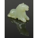 A small carved jade figure of a recumbent horse. Length 6.5cm Height 4cm.