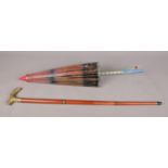A vintage wood and brass walking stick cane together with a vintage parasol. To include an