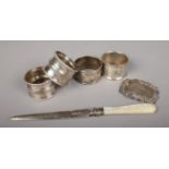 Six pieces of silver. To include four napkin rings, all assayed in Birmingham 1917 & 1918 by