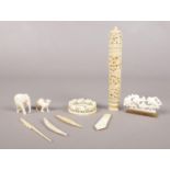 A group of mostly ivory pieces. To include a napkin ring , an small elephant and book mark etc.