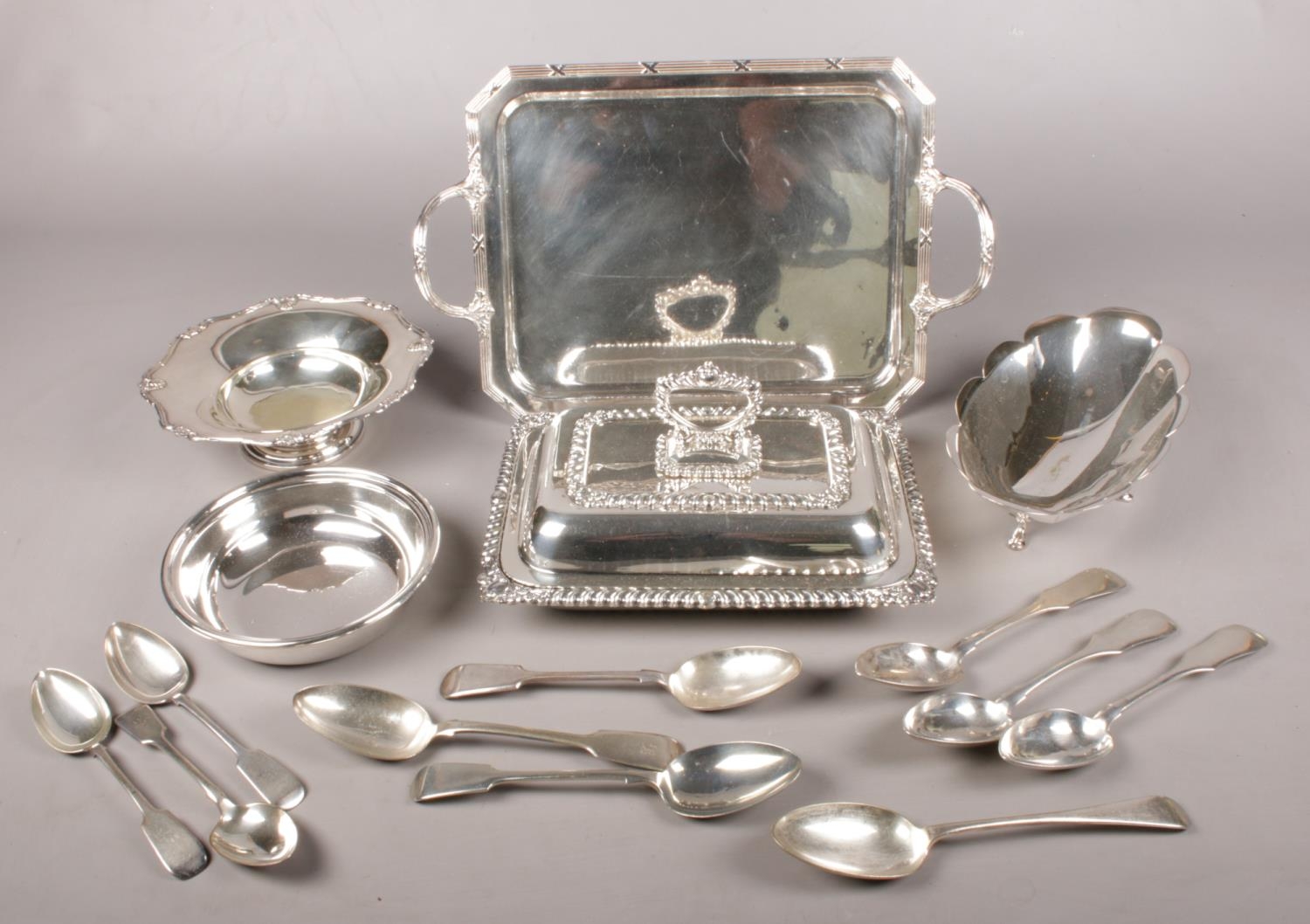 A collection of silver plated items. Includes tureen, tray, dishes, table spoons etc.