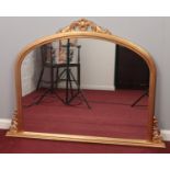 A gilt framed dome top over mantel mirror. (106cm x 143cm)