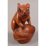 A carved boxwood netsuke formed as a rat.