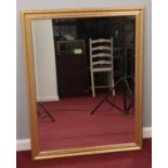 A gilt framed bevel edged wall mirror. (100cm x 76cm)