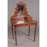 A mahogany three drawer dressing table with glass top.