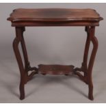 A carved mahogany serpentine two tier side table. (78cm x 75cm)