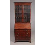 A Georgian style mahogany bureau bookcase. Crack to section of glass.