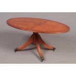 A Yew wood Regency style oval coffee table.