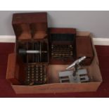 A box of scientific instruments. Including Galvometer, bridge testers, microscope, etc.