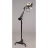 A Horstman Pluslite mid 20th century adjustable counter balanced standard lamp on a tripod caster