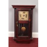 A wooden cased wall clock with pendulum. (55cm h, 28cm w)