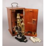 An early 20th century lacquered brass microscope by Otto Himmler, No. 13114. In mahogany case.