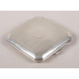 A silver cigarette case of square form with cantered corners. Assayed Birmingham 1928 by Henry