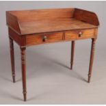 A Regency mahogany wash stand raised on turned tapering supports with gallery top. Some damage to