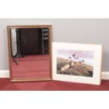 A gilt framed mirror & a print of a rural scene.