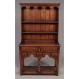 A Titchmarsh & Goodwin oak kitchen dresser of small proportions. (162cm x 92cm x 36cm)