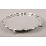 A silver card tray raised on four scrolled feet. Assayed Sheffield 1965 by Francis Howard Ltd. 346g.