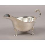 A silver sauce boat raised on stepped feet. Assayed Birmingham 1965 by Walker & Hall. 234g. Good