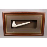 A large decorative Meerschaum pipe in frame.