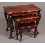 A carved Mahogany nest of three tables. H: 55cm, W:68cm, D:40cm. Condition fair. A few scratches and