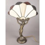 An art deco style figural table lamp with fan shape shade. Shade cracked to the bottom.