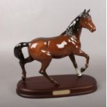 A Royal Doulton brown glazed horse figure. 'Spirit of the Wind' on a wooden base, 26cm W.