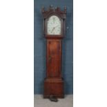 A Victorian oak longcase clock. Painted dial with floral decoration.