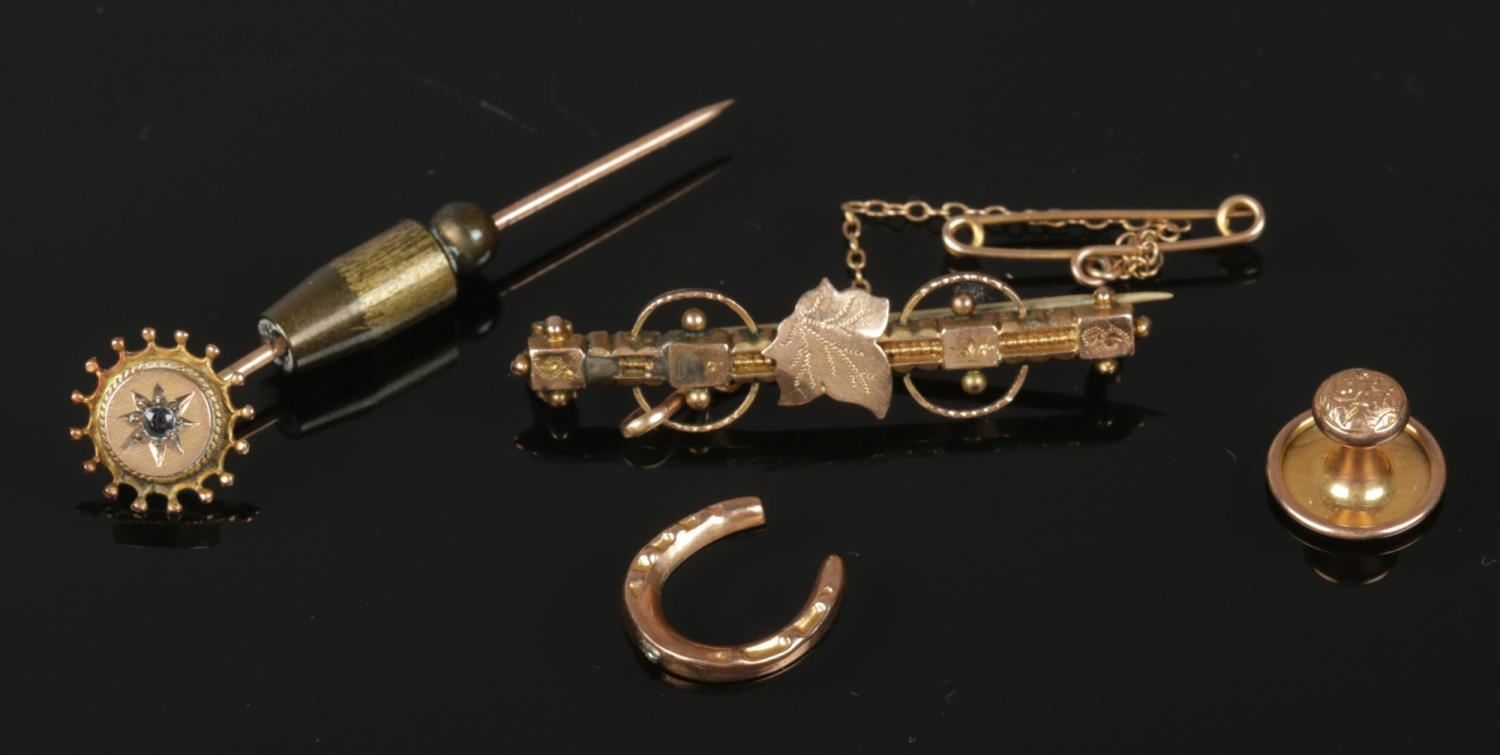 Four oddments of 9ct gold. To include a brooch, horseshoe, weight and pin. Total weight: 4.82g.