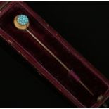 An antique 15ct rose gold and turquoise stick pin, boxed.