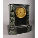 A Victorian black slate and green marble cased mantle clock, the eight day movement by Rollin of