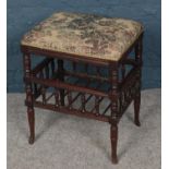 A turned mahogany upholstered piano stool.