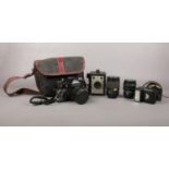 A Zenit 11 35mm camera with three lenses, flash gun and a Coronet Ambassador camera. Comes with