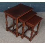 An Oak stained nest of three tables. H:47cm, W:48cm, D:33cm.