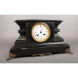 A large black slate mantle clock. Comprising of a white enamel dial with roman numerals and marked R