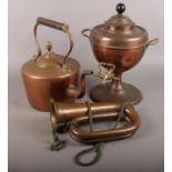 A copper samovar along with a copper kettle and bugle.