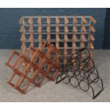 Three wine racks. Includes large 48 bottle example, small iron example and one other.